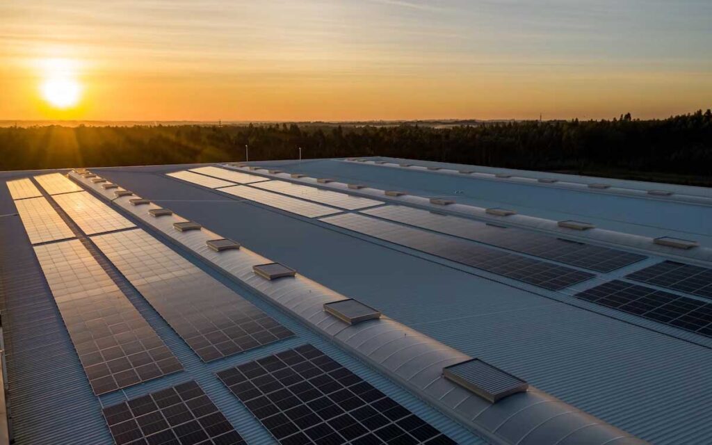 Sunrise over a rooftop covered in solar panels