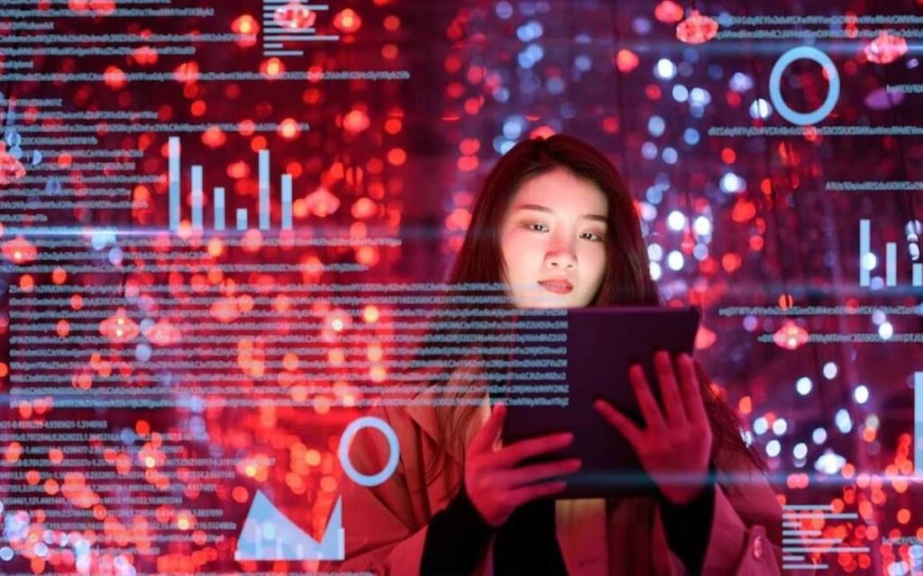A young woman holds a tablet against a background of graphic charts and text computer science skills