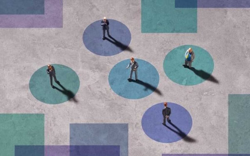 A graphic illustration of interconnected businesspeople standing in circles against a color-blocked background