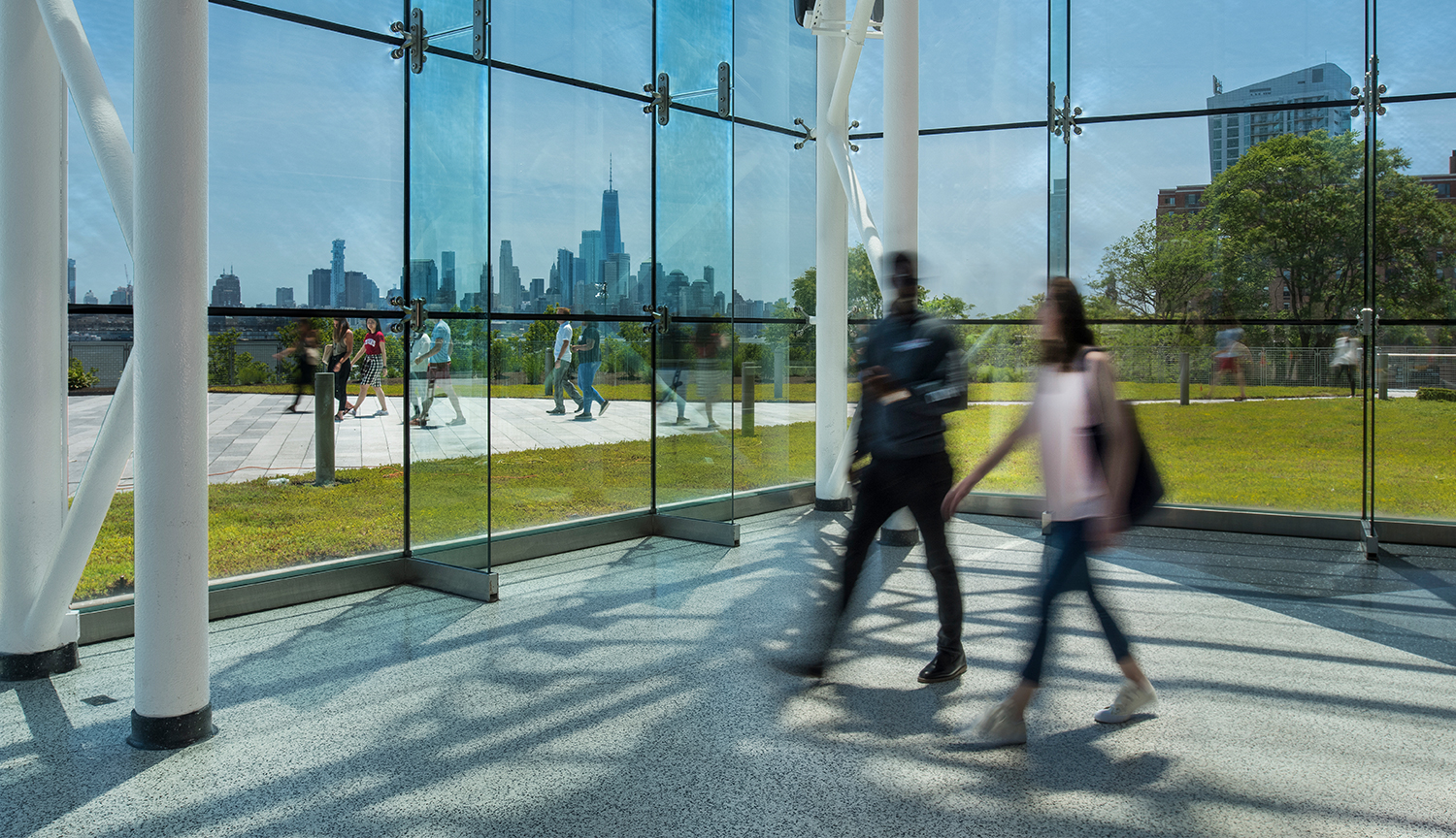 Students walking around campus during a sunny day.