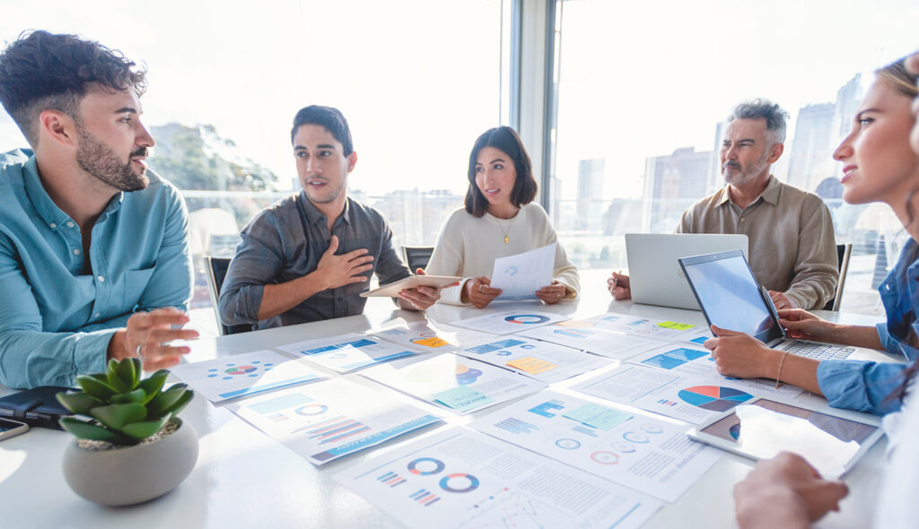 A group of colleagues in the middle of a discussion.sit around a table.