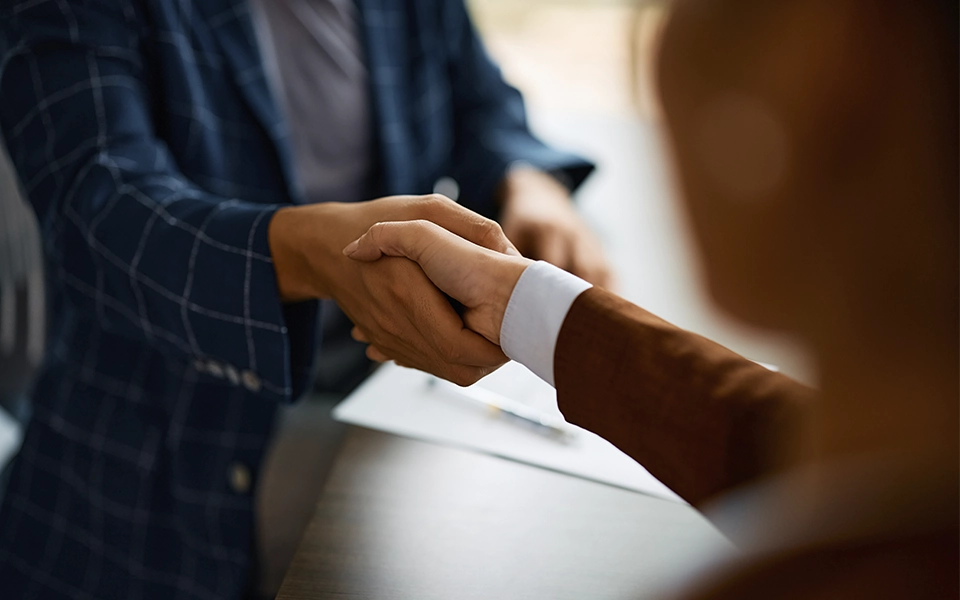 Two people shaking hands.